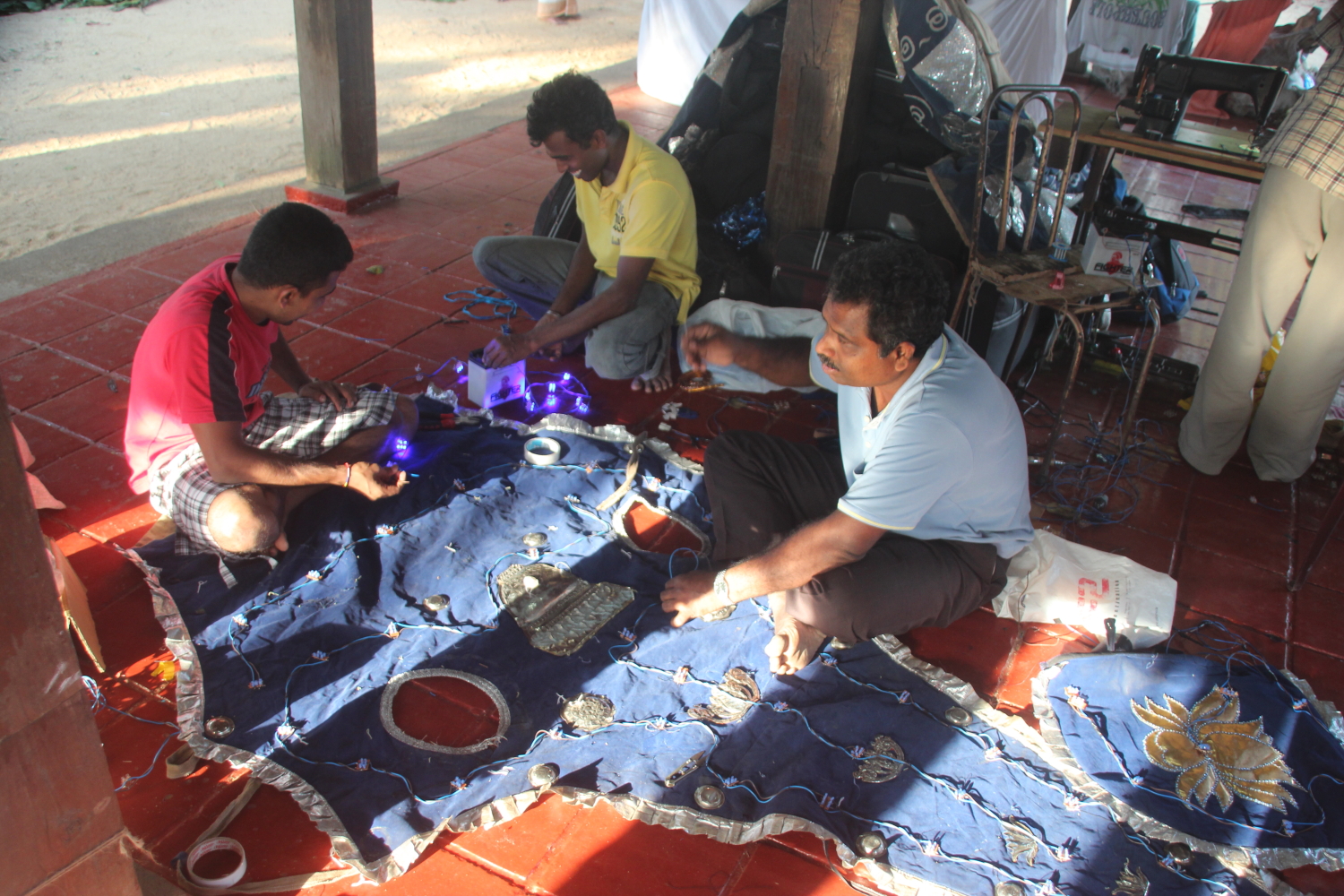 Mending an elephant's headdress, Kandy, Sri Lanka